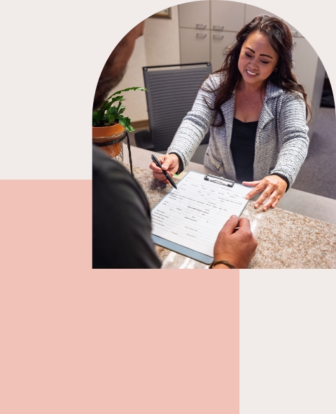 Dental Office Staff Assisting Patient With Simple Payment Options at Front Desk